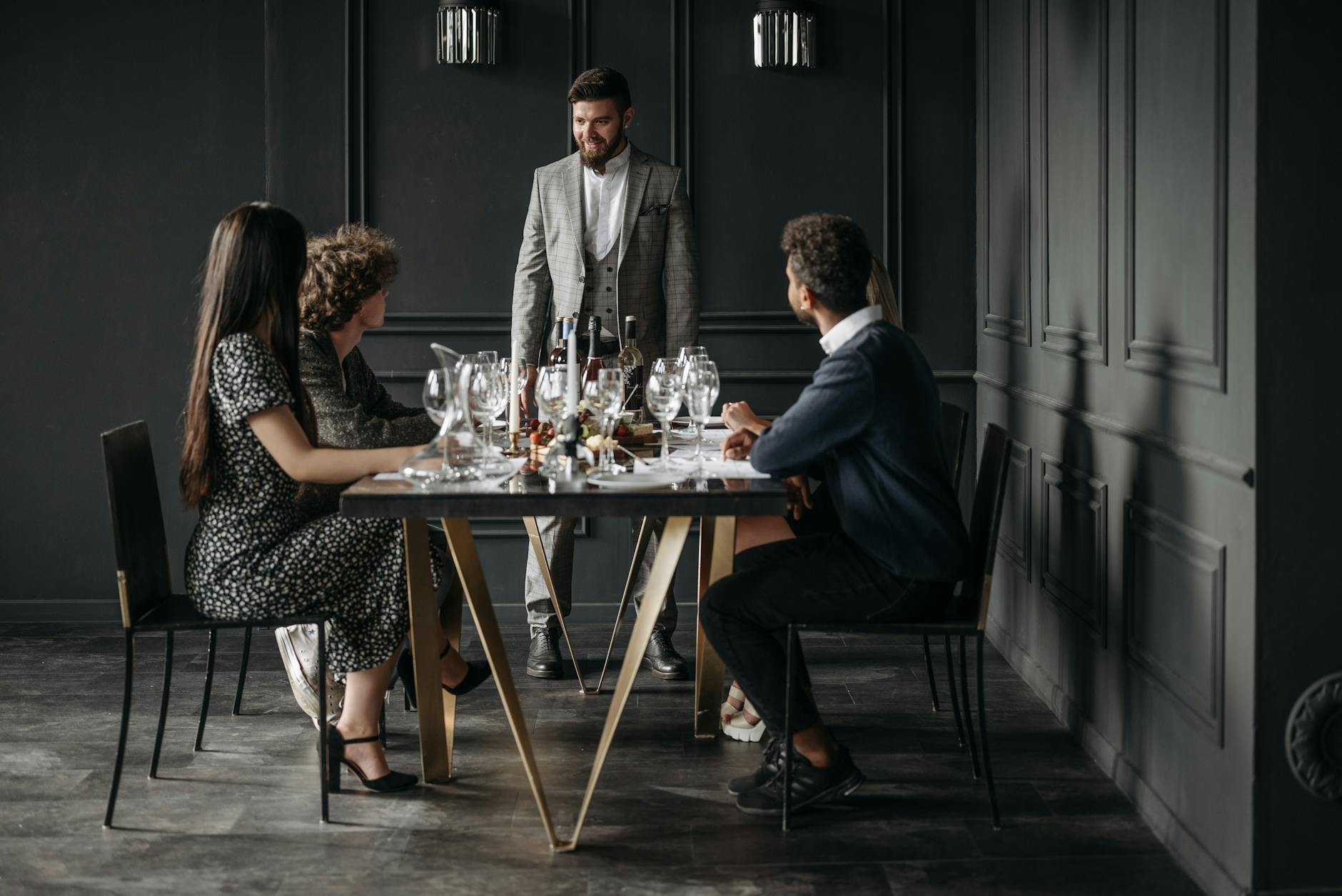 A sophisticated wine tasting event with diverse adults enjoying drinks indoors.