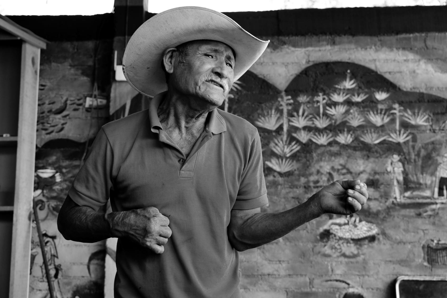 Black and white portrait of an elderly man wearing a hat, captured in the streets of Oaxaca, Mexico.