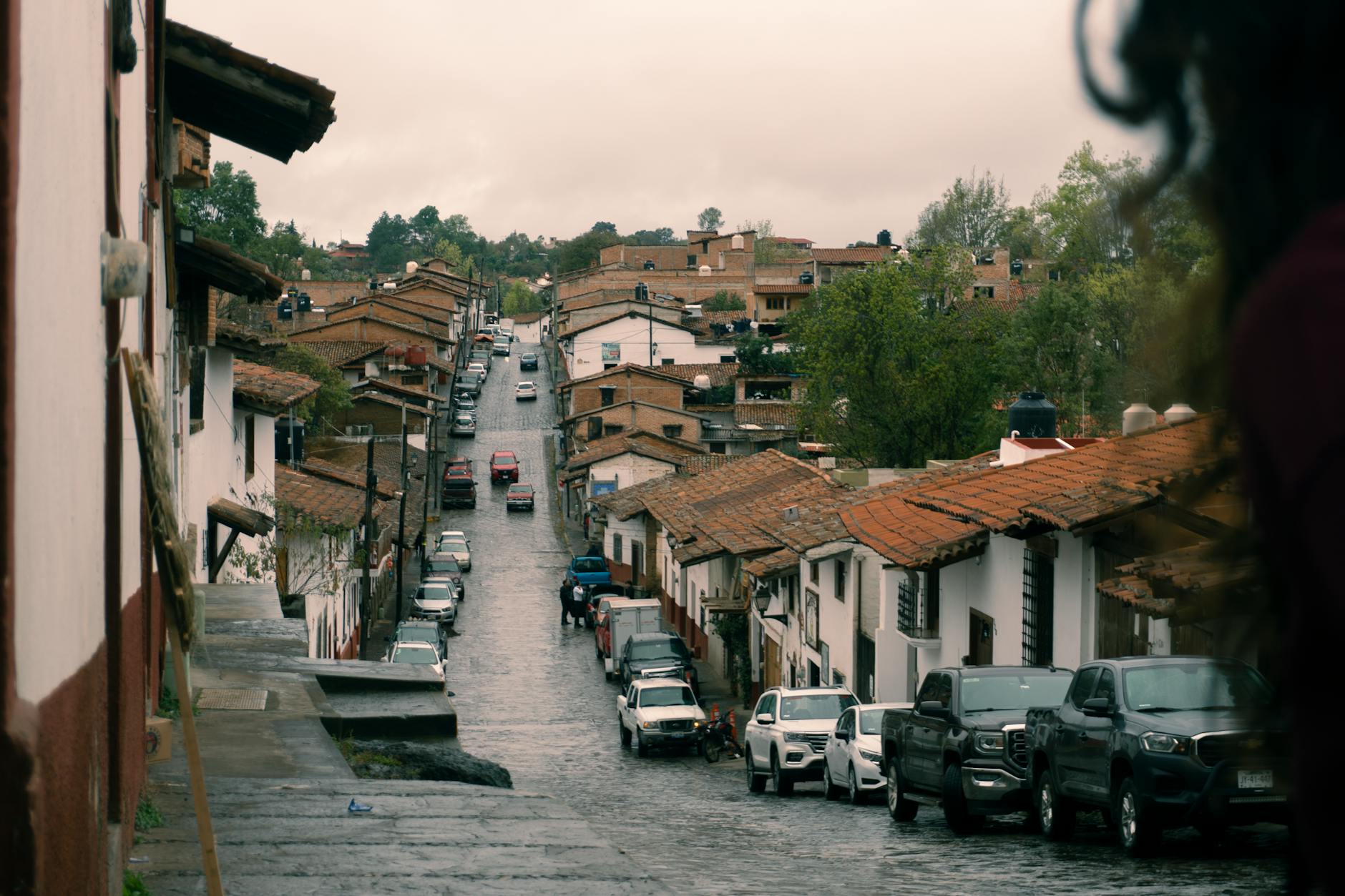 Cobblestone street with traditional houses in Tapalpa, Jalisco, Mexico on a cloudy day.