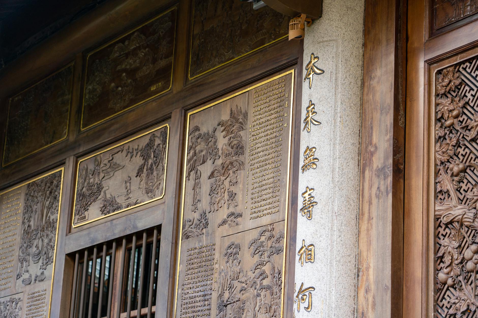 Detailed image of traditional Asian temple wood carvings with artistic engraved designs.