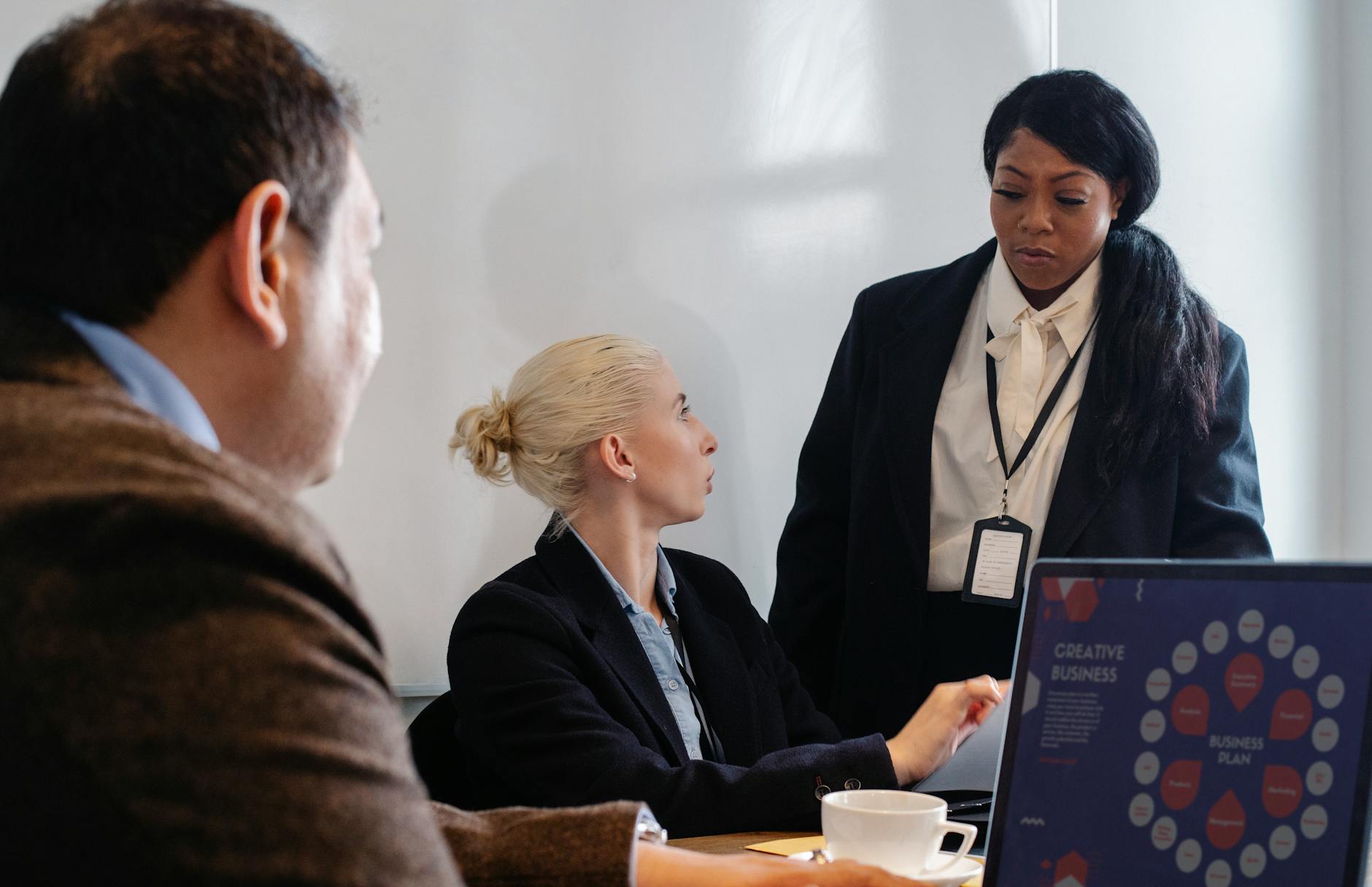 Diverse professionals engage in a strategic brainstorming session at the office desk.
