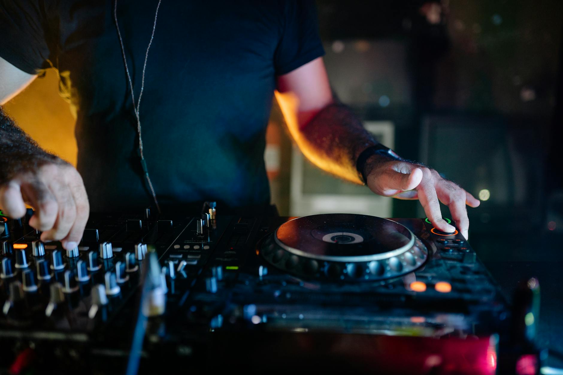 DJ mixing tracks in a vibrant nightclub setting, full of energy and music.