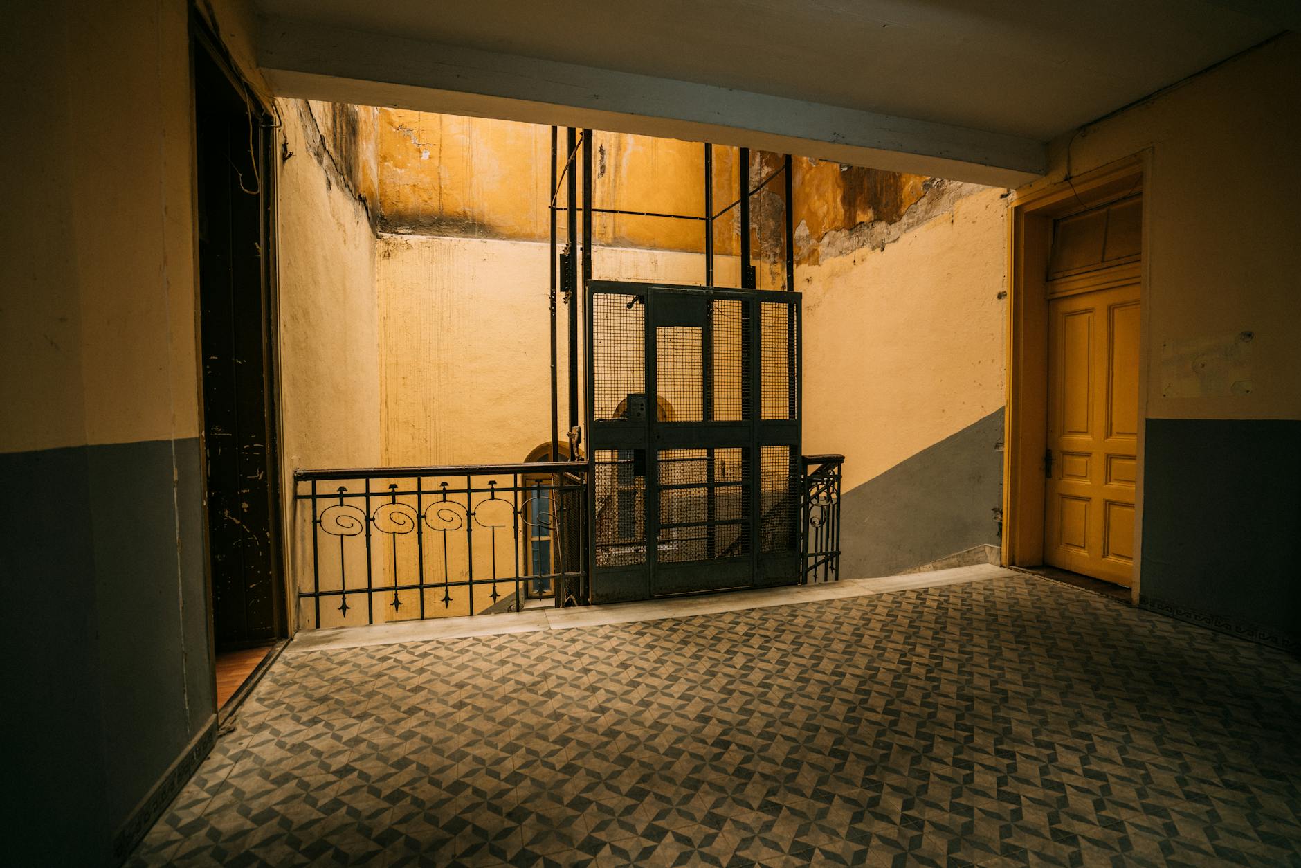 Como Aproveitar As Festas De Lisboa Sem Filas Nem Empurrões 7 Old elevator in a vintage hallway with geometric tiled floor. Rustic charm and design.