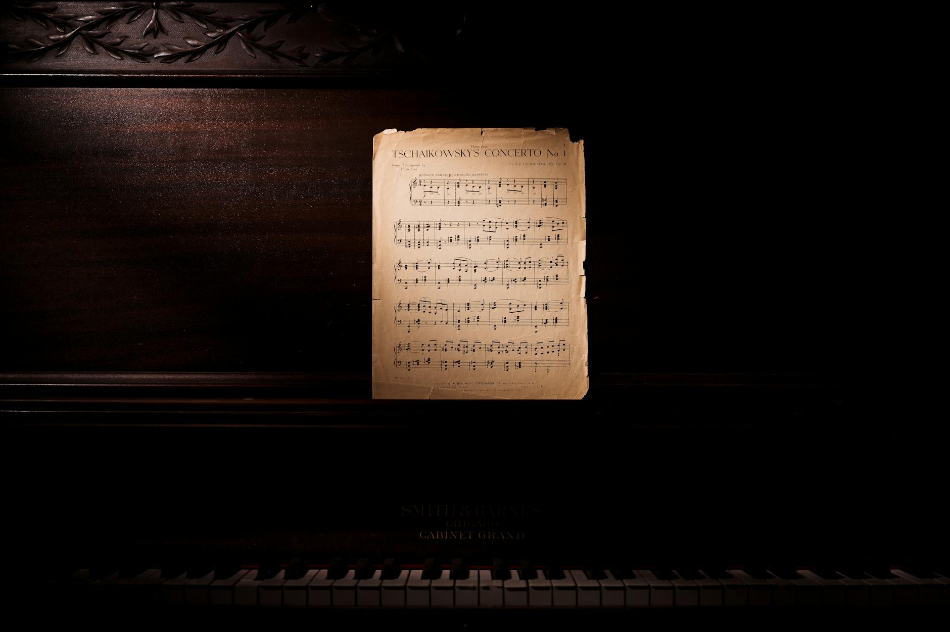 A classic piano with Tchaikovsky's concerto sheet music, evoking a nostalgic, musical ambiance.