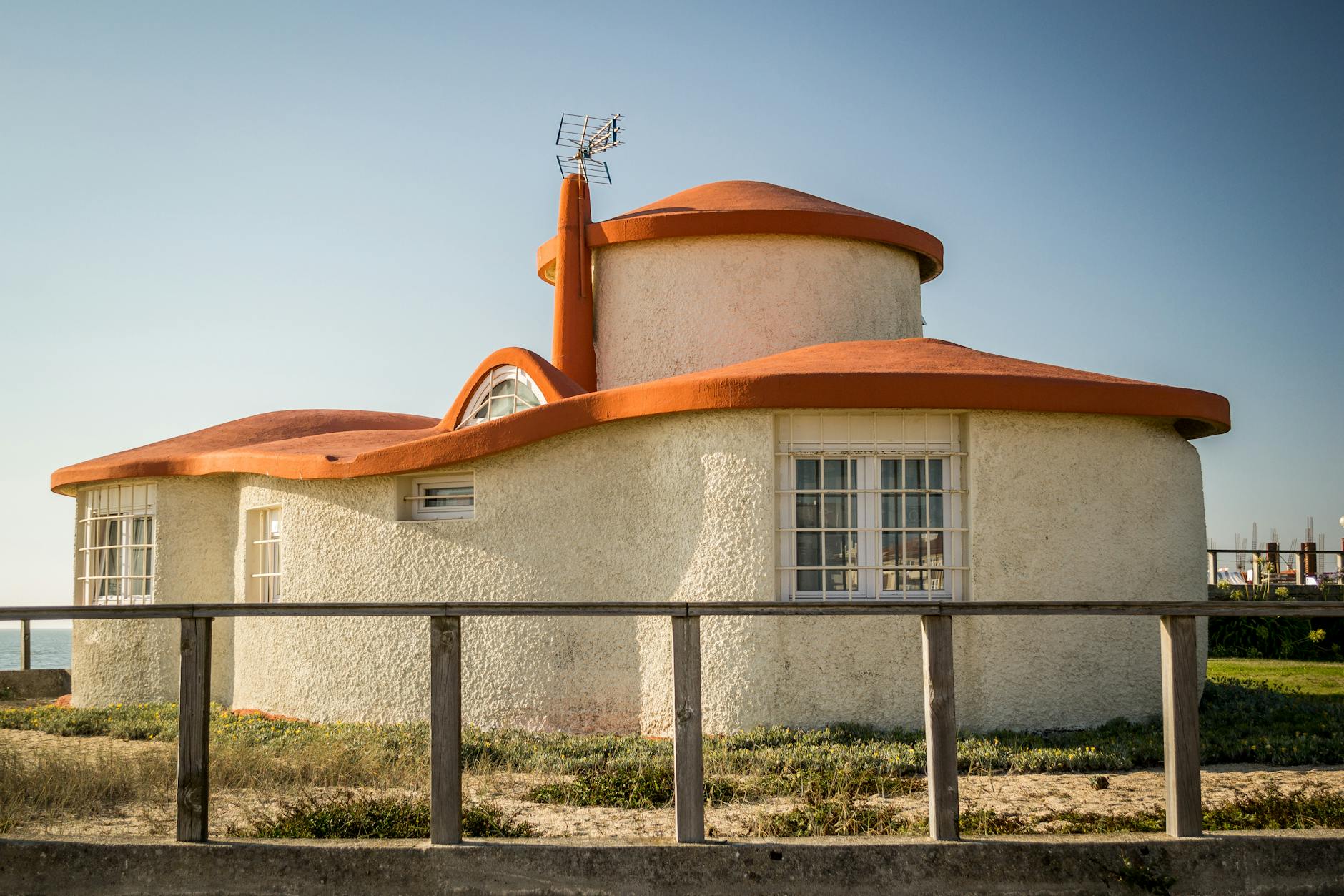 A distinctive round house with an orange roof by the coast in Ver-o-Mar, Portugal.