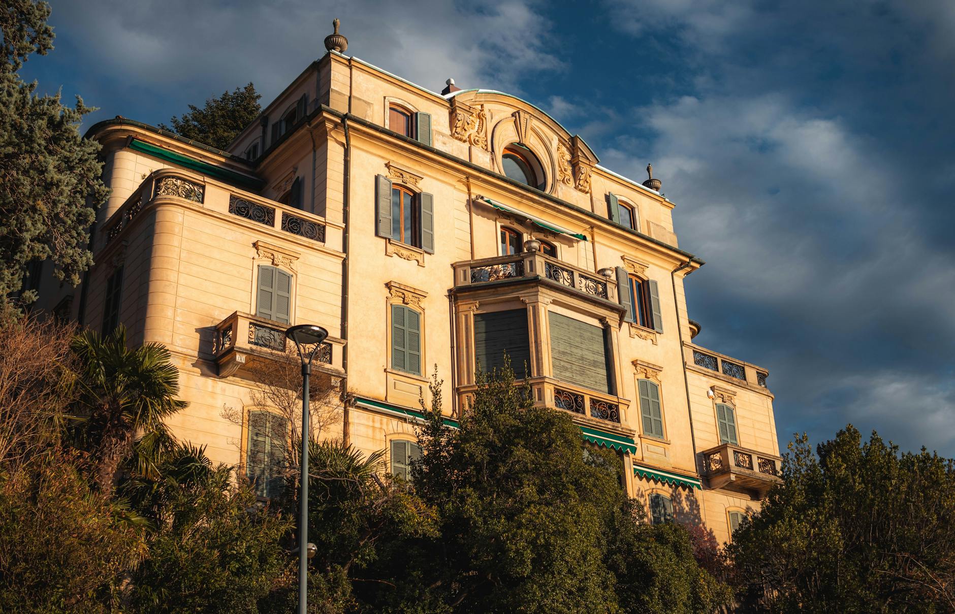 A grand mansion in Como, Italy with stunning architectural details, captured at sunset.