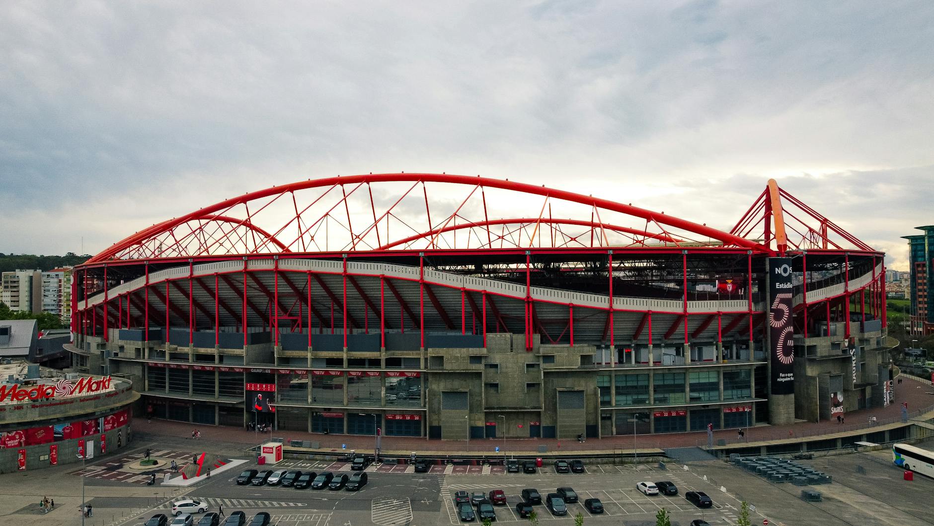 Aerial shot of the iconic Estádio da Luz in Lisbon, known for its striking red arches and modern architecture.