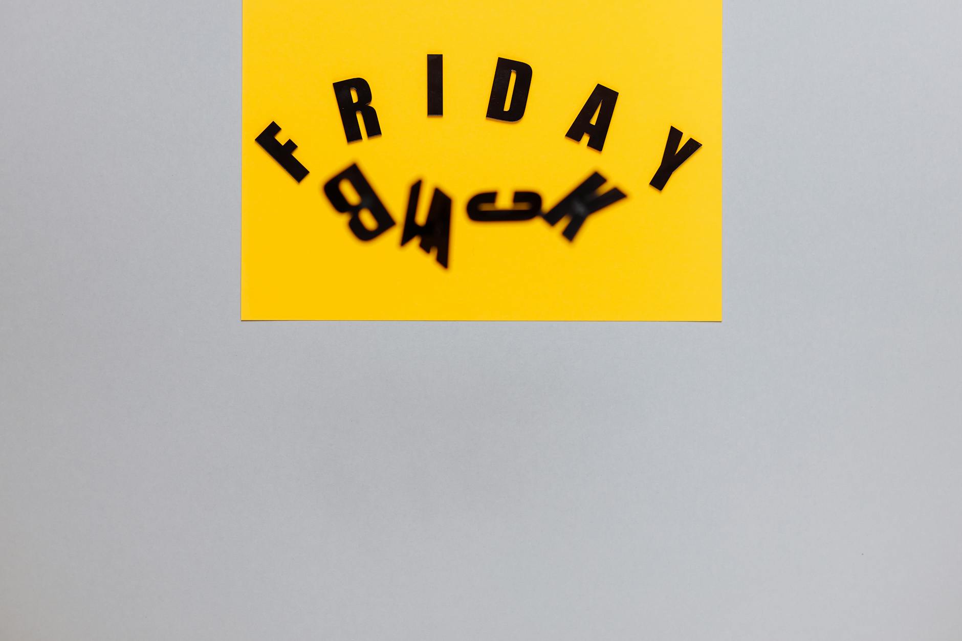 An abstract Black Friday design with bold letters on a yellow card, ideal for marketing.