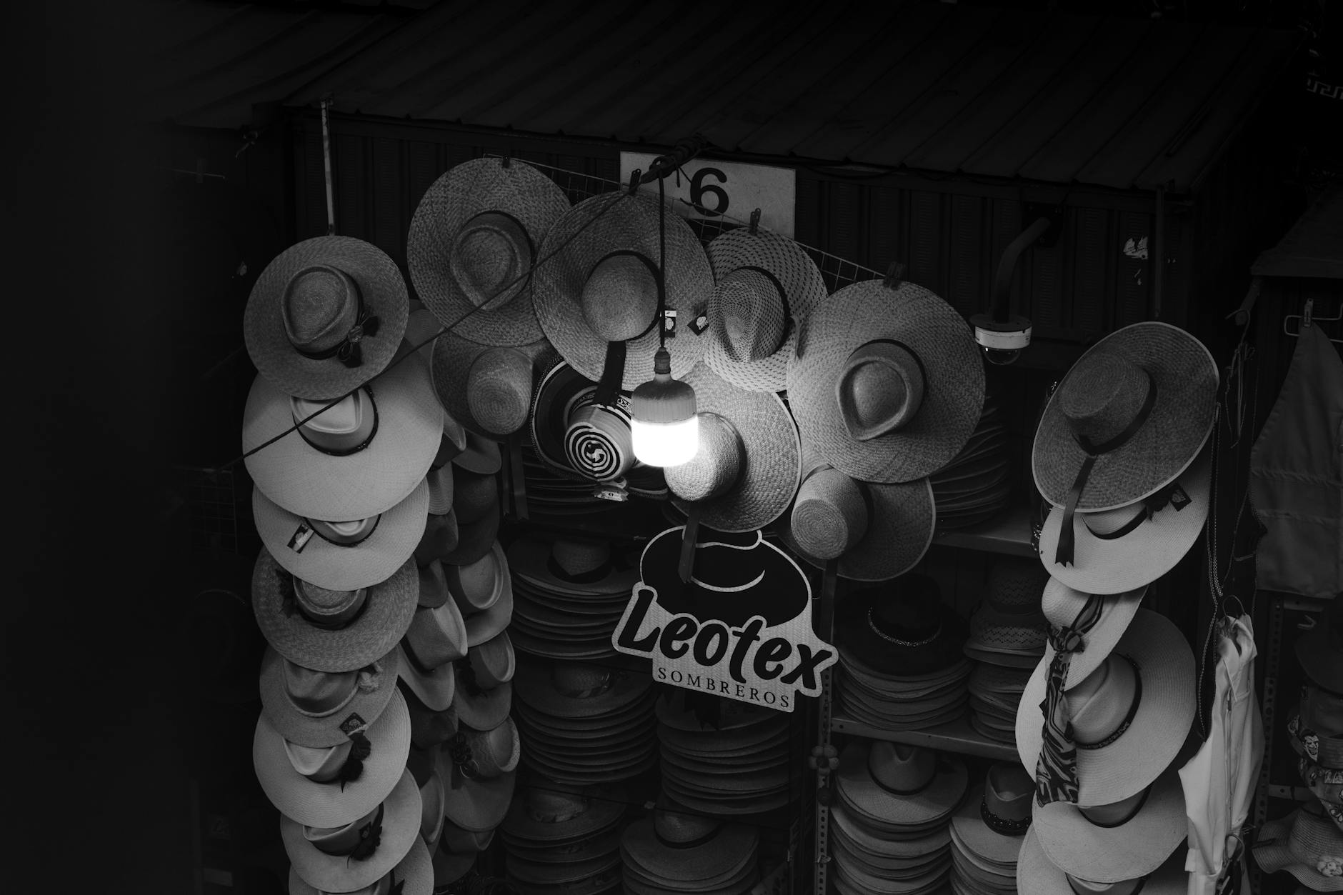 Artistic black and white photo of a hat stall in Arequipa's local market, Peru.
