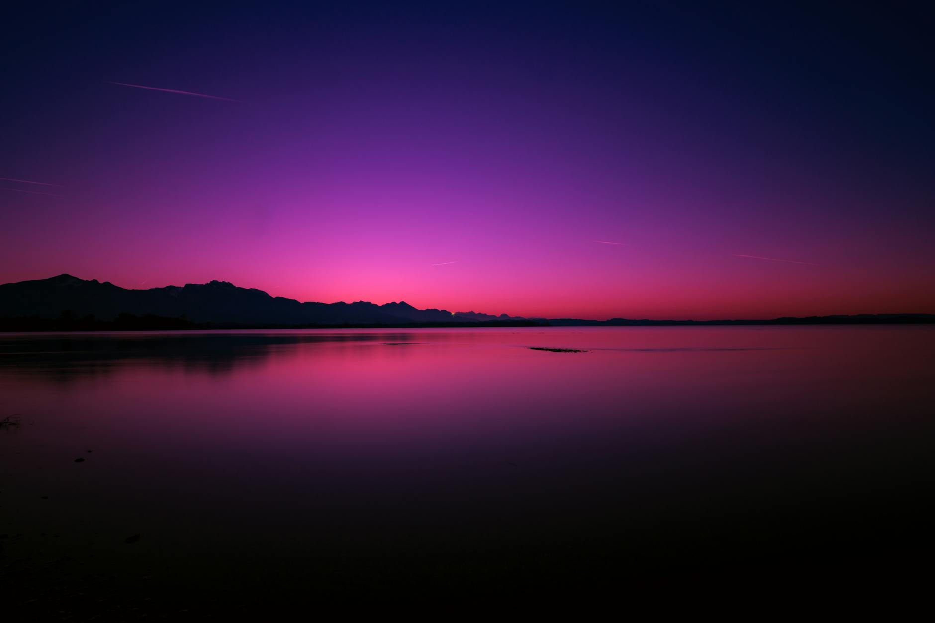 Breathtaking sunset over Chiemsee with vivid colors and tranquil waters in Bavaria, Germany.