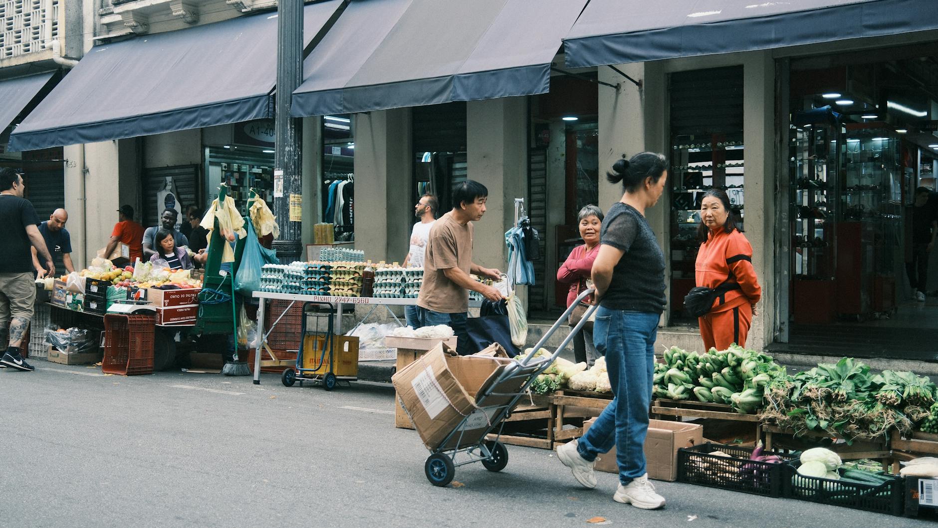 Bustling street market scene in São Paulo with fresh produce and local shoppers.