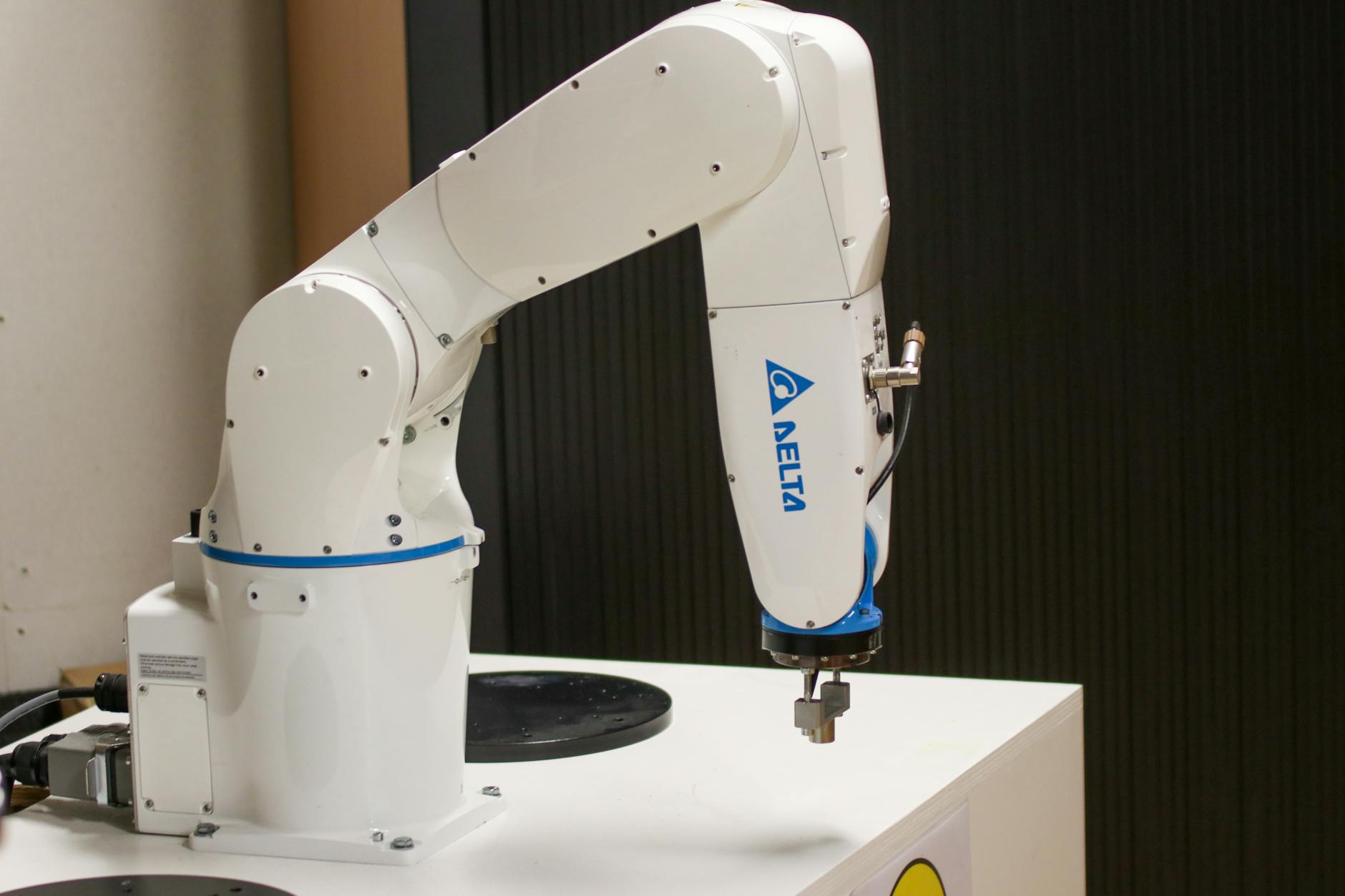 Close-up of a Delta brand robotic arm in an industrial setting, showcasing automation technology.
