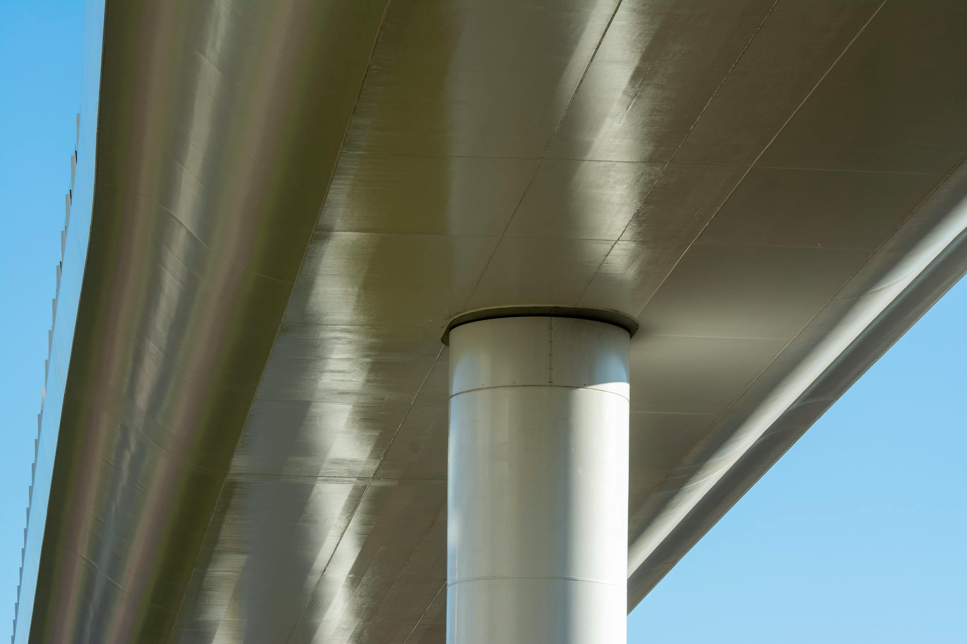 Close-up of a modern steel bridge pillar highlighting architectural design.