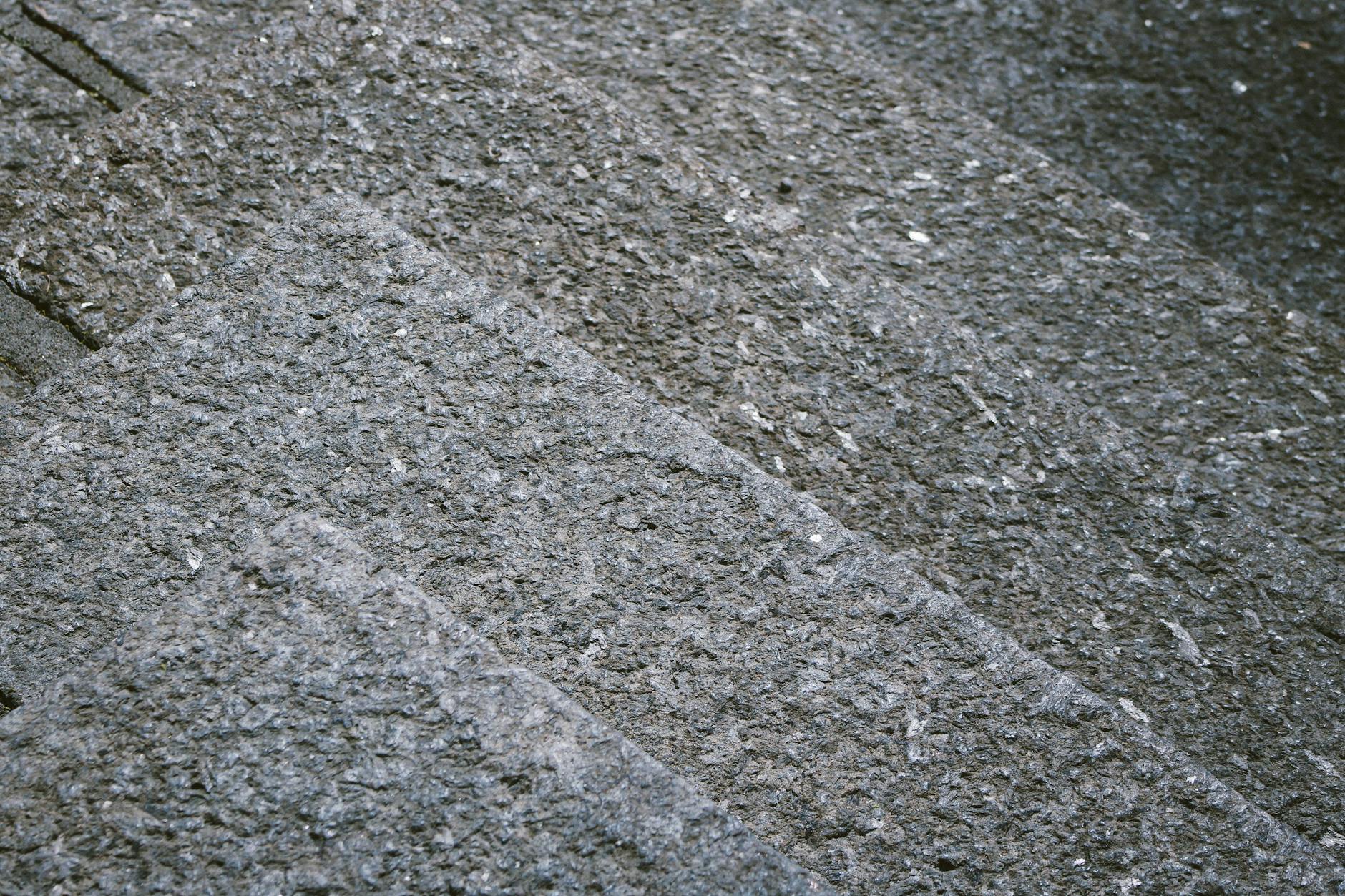 Close-up of textured granite steps showcasing a rough, gray stone surface.