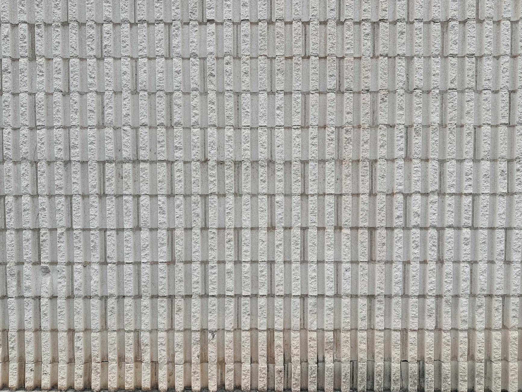 Close-up view of a textured grey brick wall, ideal for backgrounds and design projects.