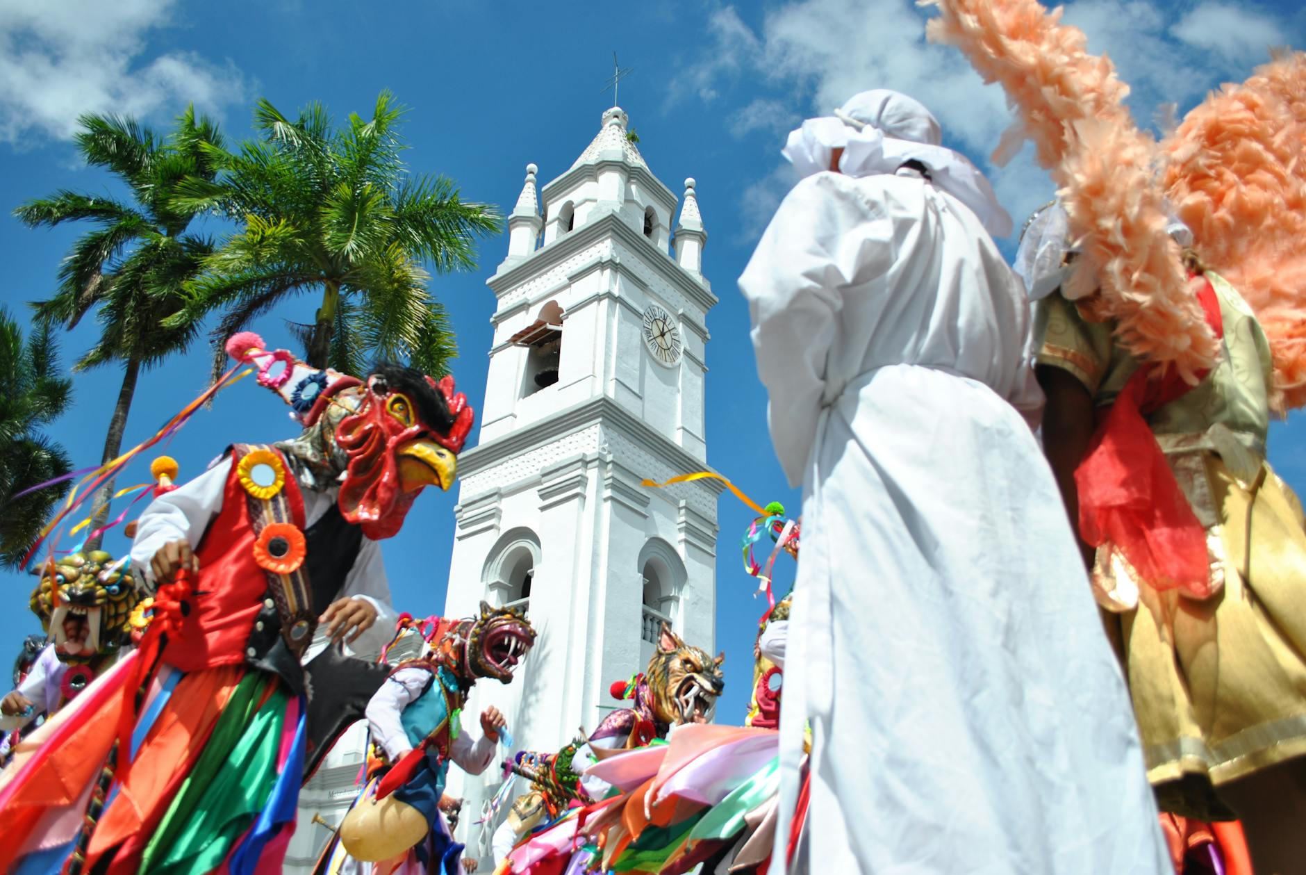 Colorful cultural celebration in La Villa de Los Santos, Panama featuring traditional costumes and a historic bell tower.