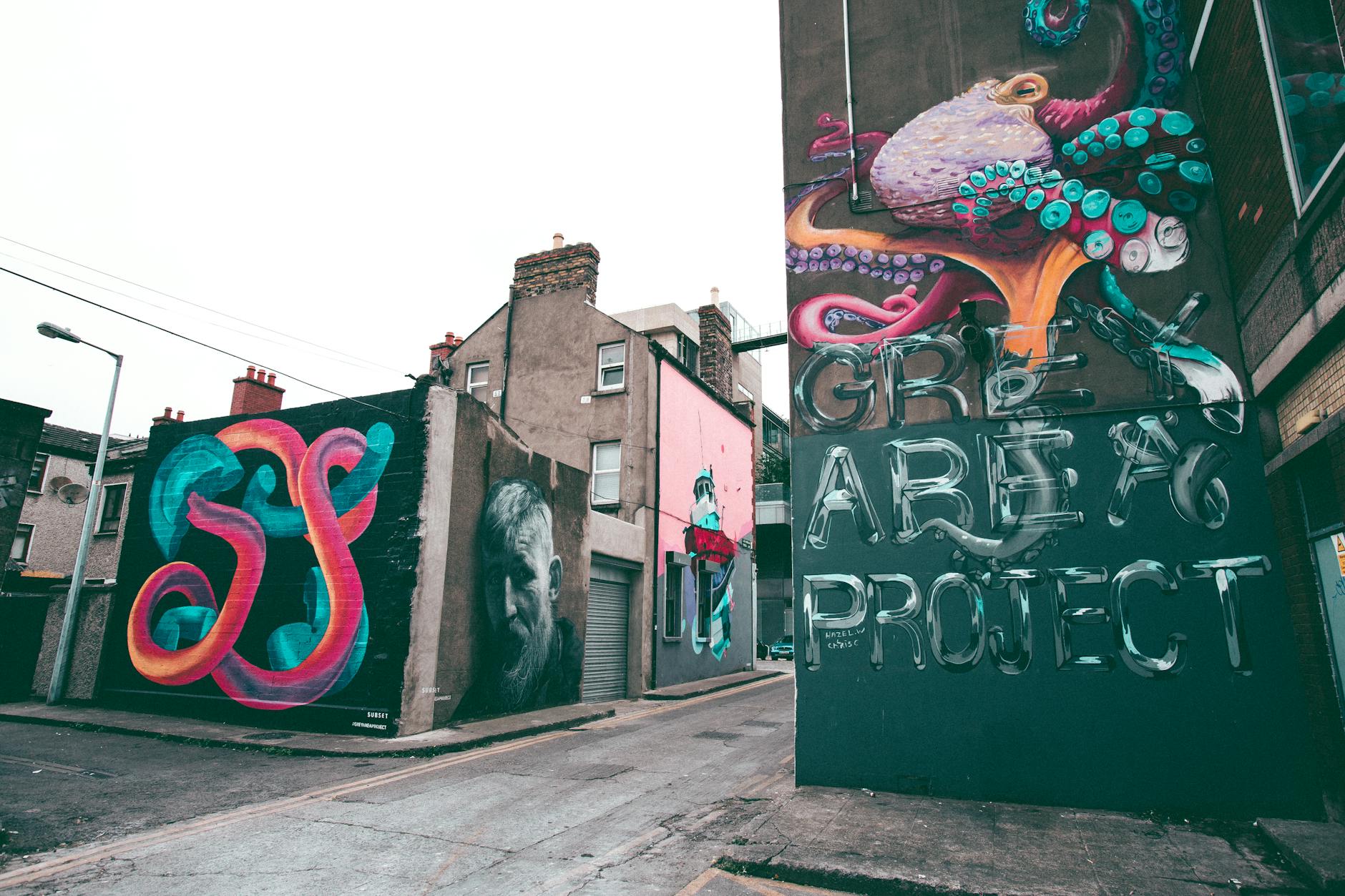 Colorful graffiti art in Dublin's alleyway, featuring abstract designs and cultural murals.