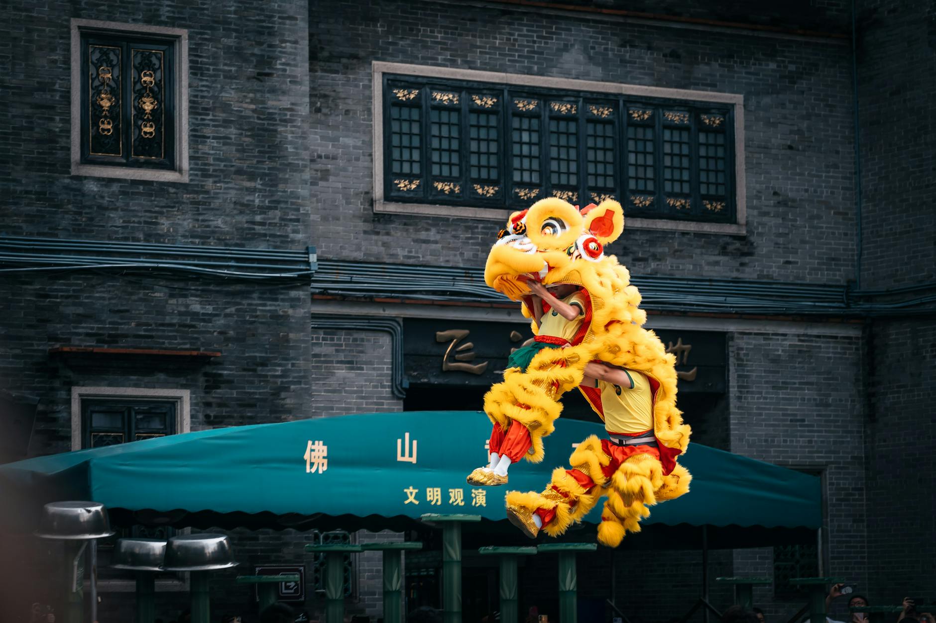 Colorful lion dance performance captured during a cultural festival in an Asian city.