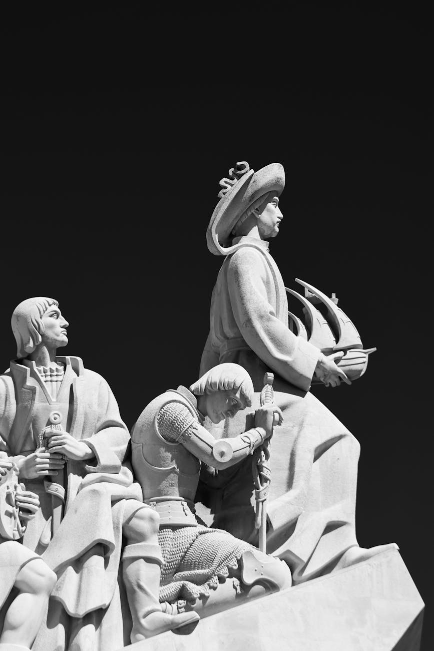 Detailed view of the Monument to the Discoveries in Lisbon captured in black and white, highlighting its intricate sculptures.