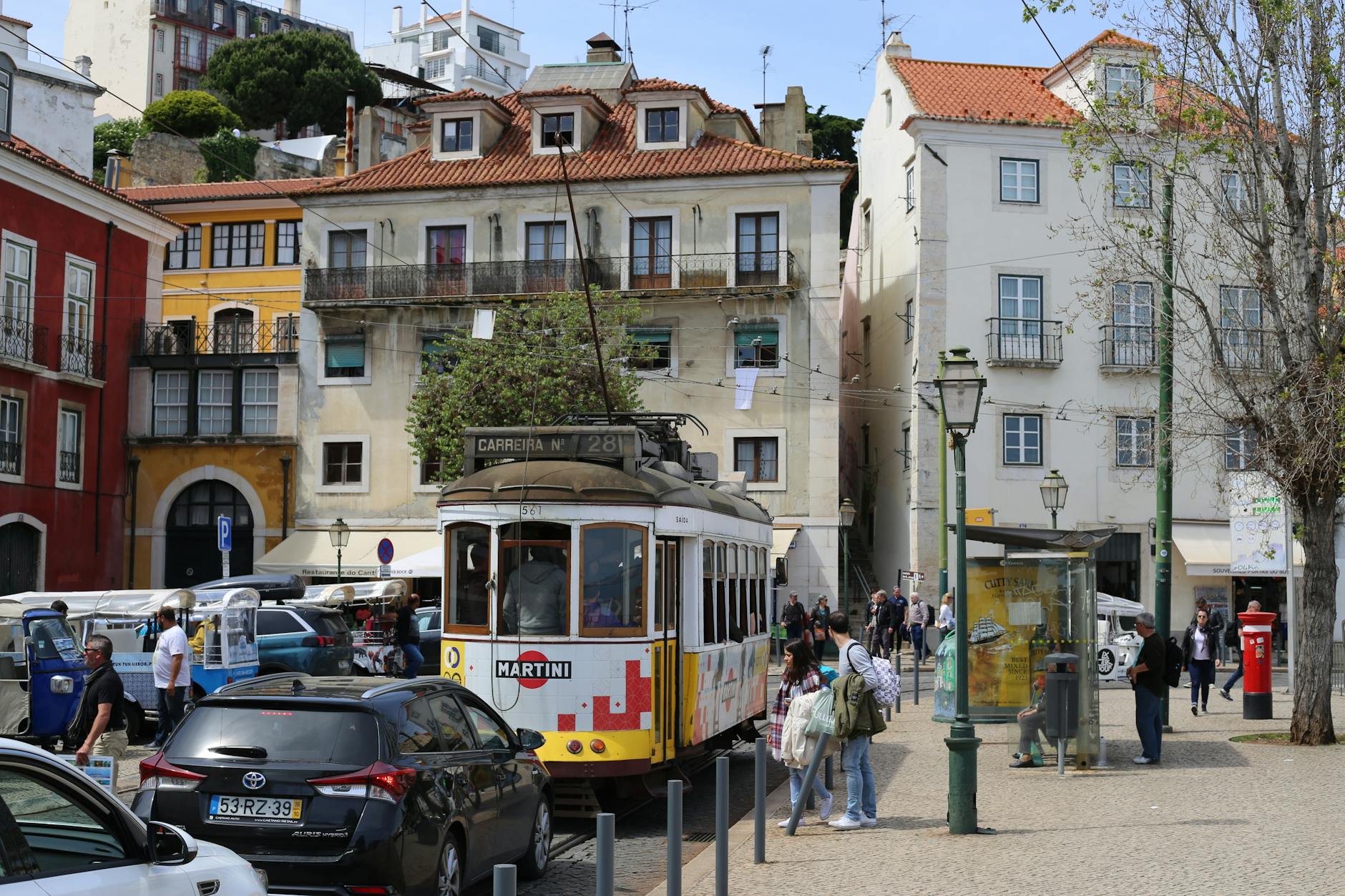Discover the vibrant streetscape of Lisbon featuring its iconic tram and colorful buildings.