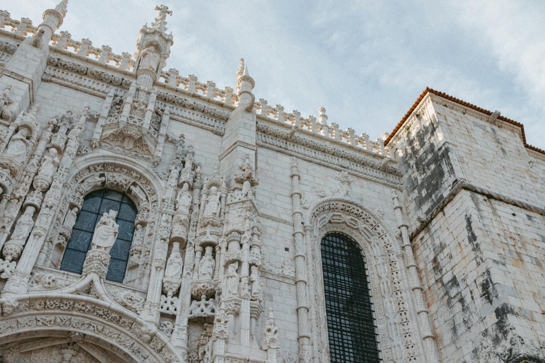 Intricate gothic architecture of Jerónimos Monastery's facade in Lisbon, Portugal.