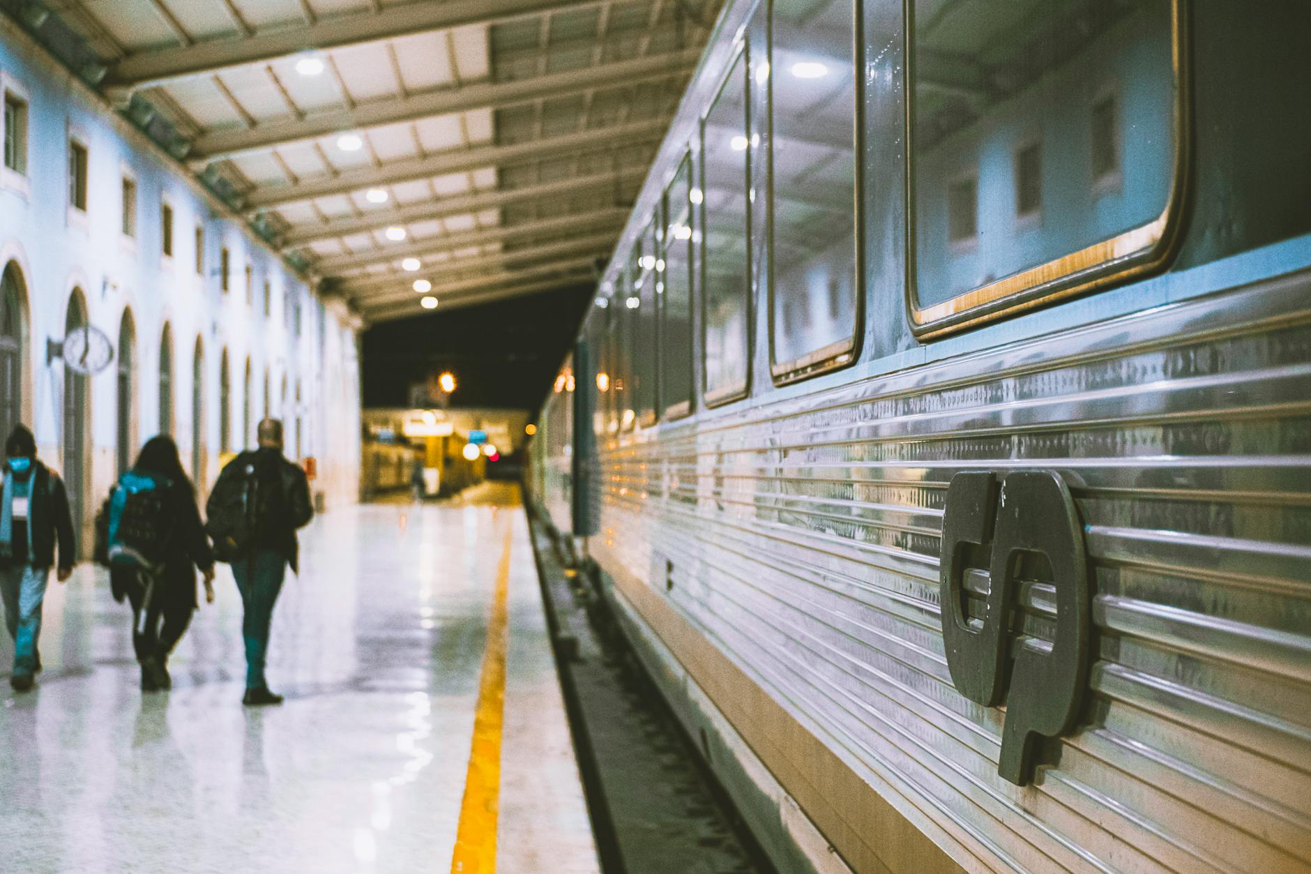 Passengers at Santa Apolónia station next to a train in Lisbon, Portugal.