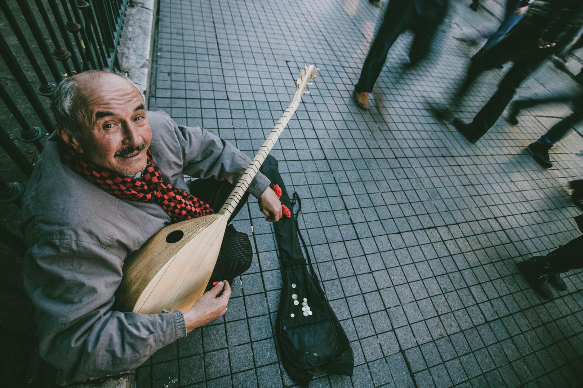 Street musician playing saz in bustling Istanbul, capturing vibrant city life.