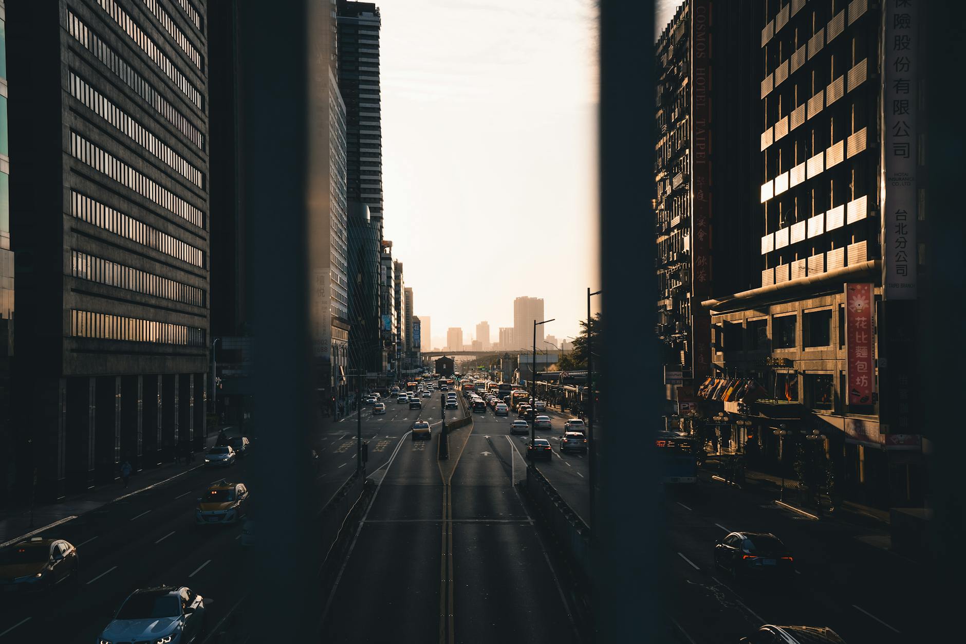 Street photography of a bustling urban cityscape with high-rises during sunset.