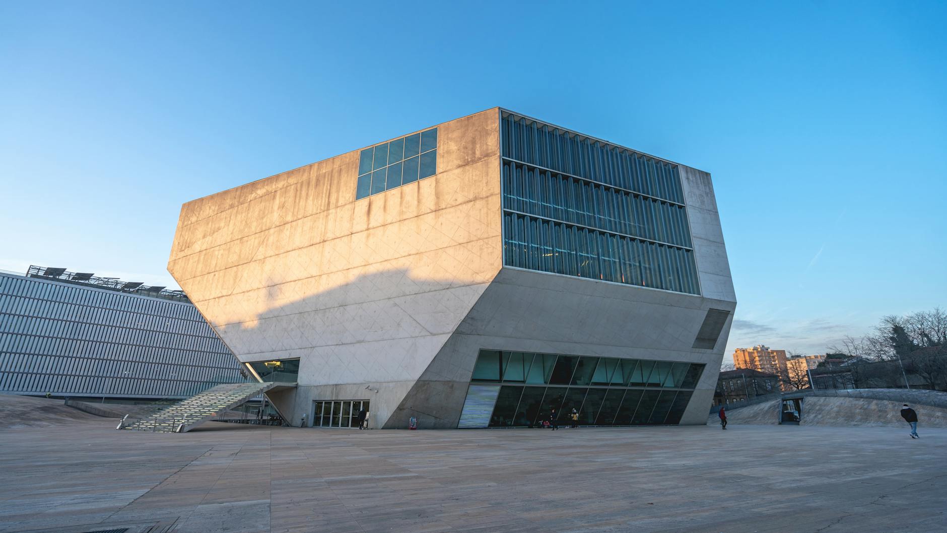 Striking design of Casa da Música concert hall in Porto, showcasing modern architectural elements against a blue sky.