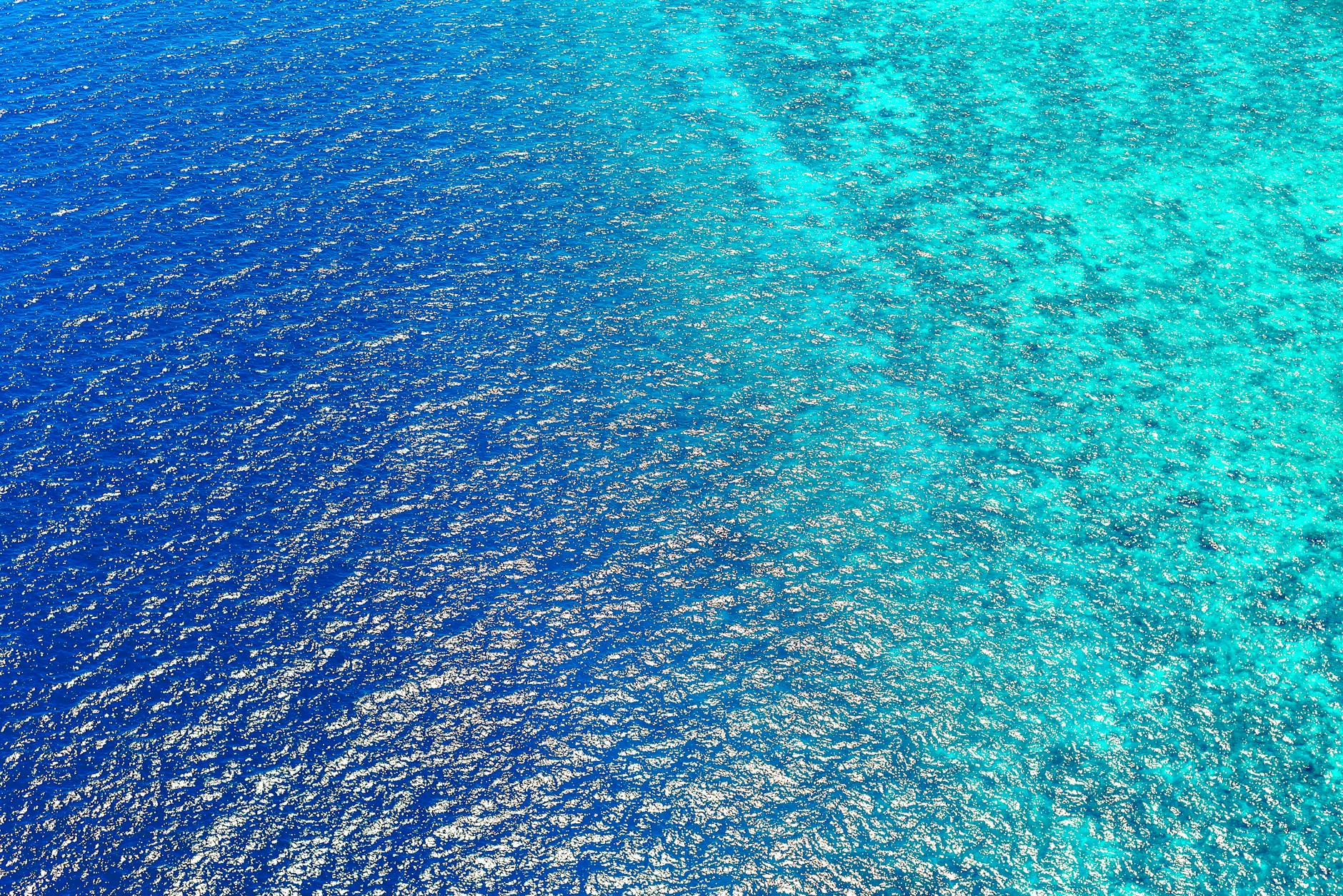 Stunning aerial view capturing the vibrant blue ocean waters of Central Kalimantan, Indonesia.