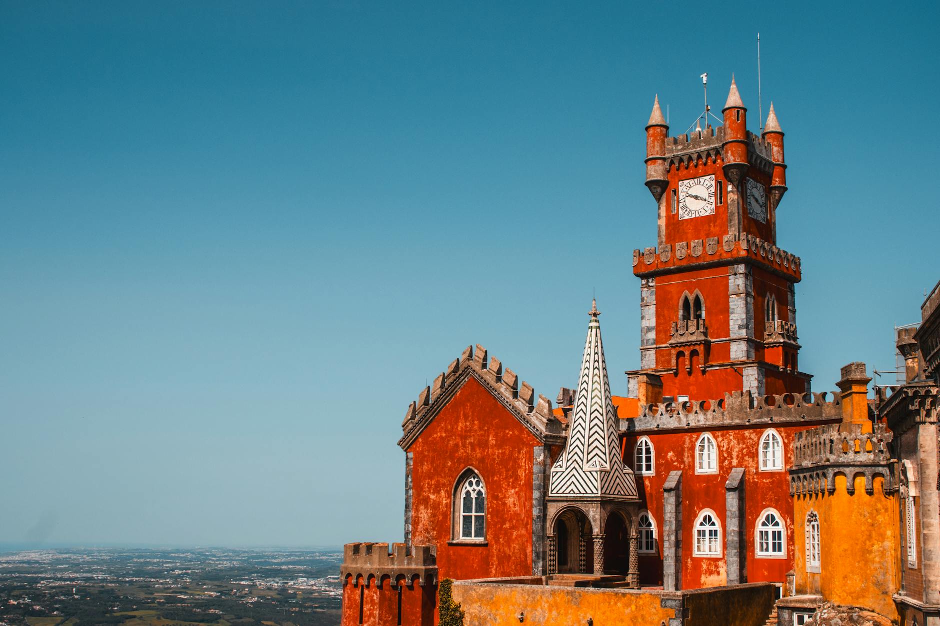 Stunning view of colorful Pena Palace in Sintra, Portugal under clear blue skies.