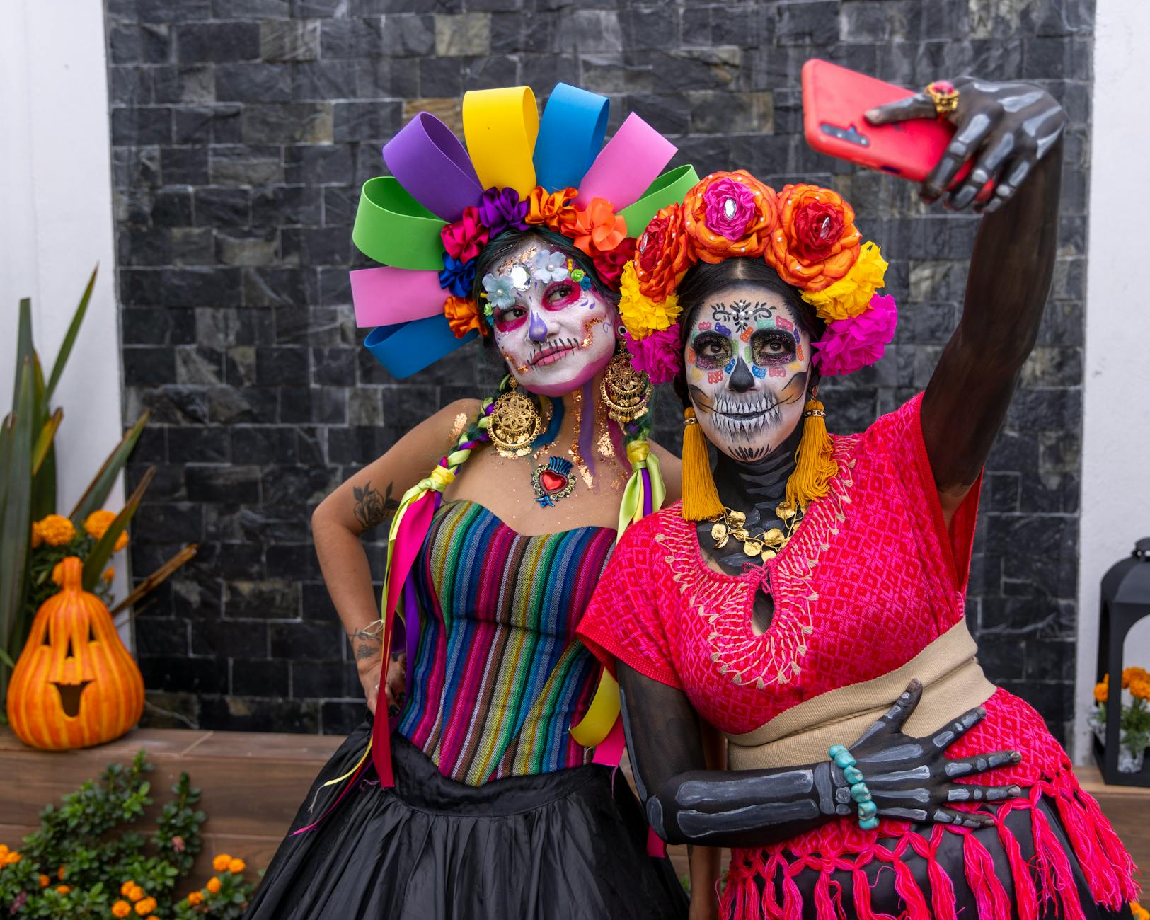 Vibrant Dia de los Muertos celebration with women in colorful Catrina makeup in Mexico City.