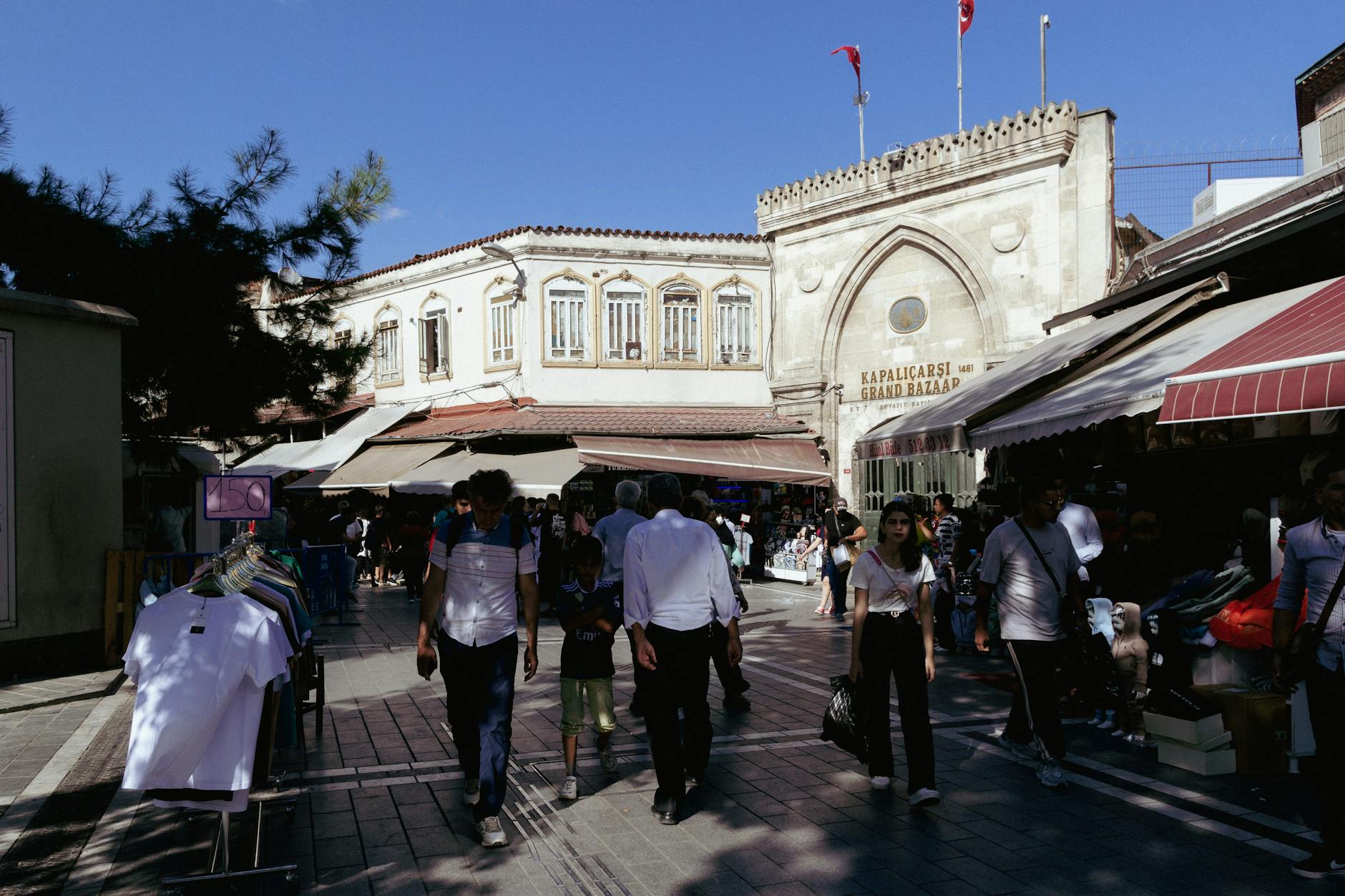 Vibrant street scene at the Grand Bazaar entrance in Istanbul, showcasing local culture and architecture.