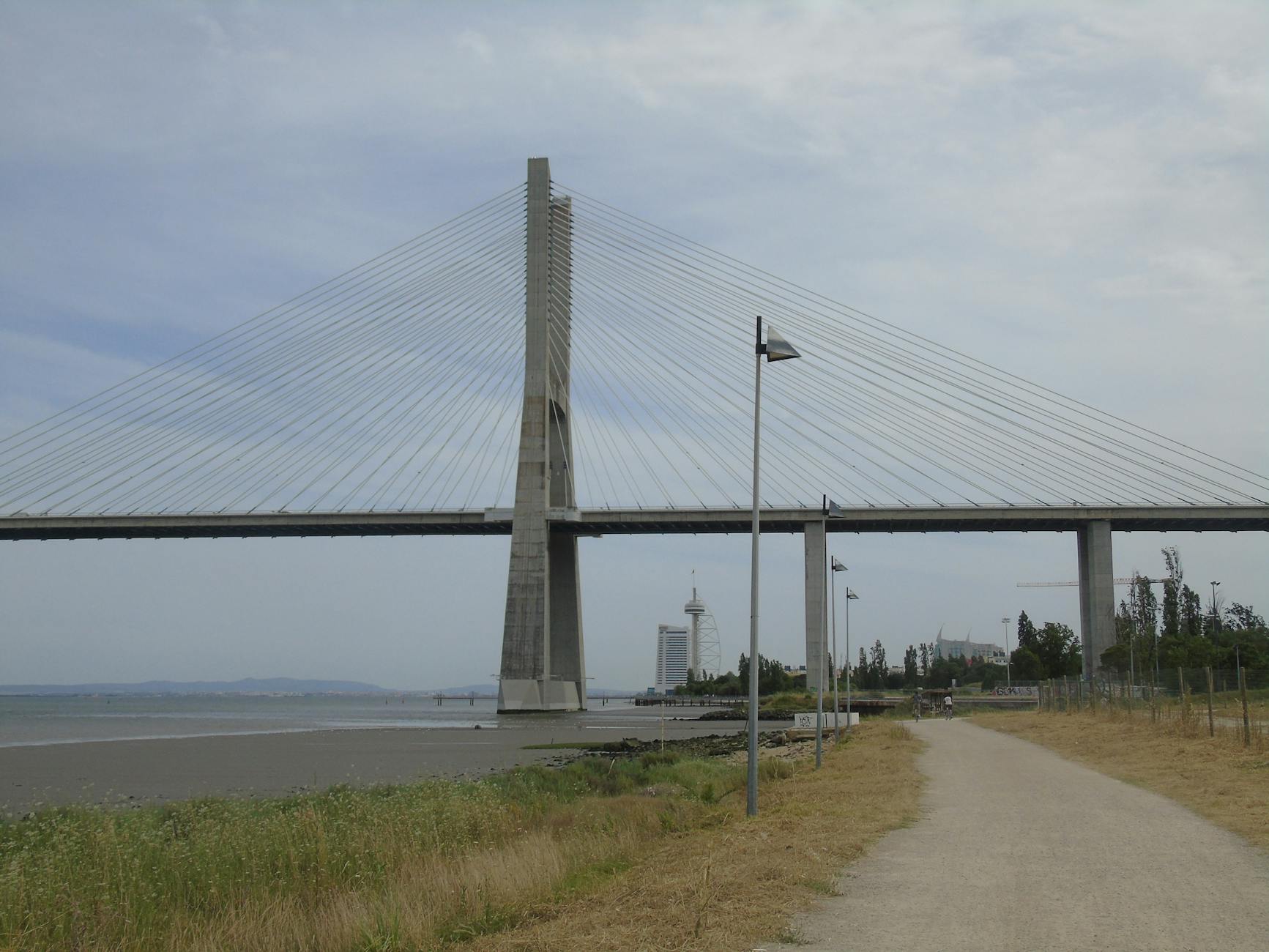 View of the Vasco da Gama Bridge spanning the Tagus River with a clear sky in Lisbon, Portugal.